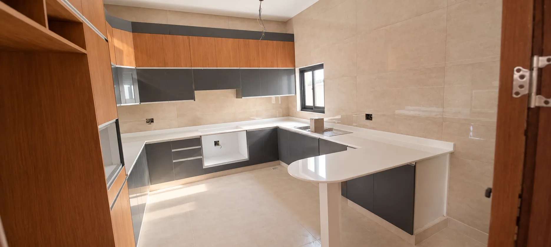 Wide walnut and charcoal kitchen with illuminated cabinetry