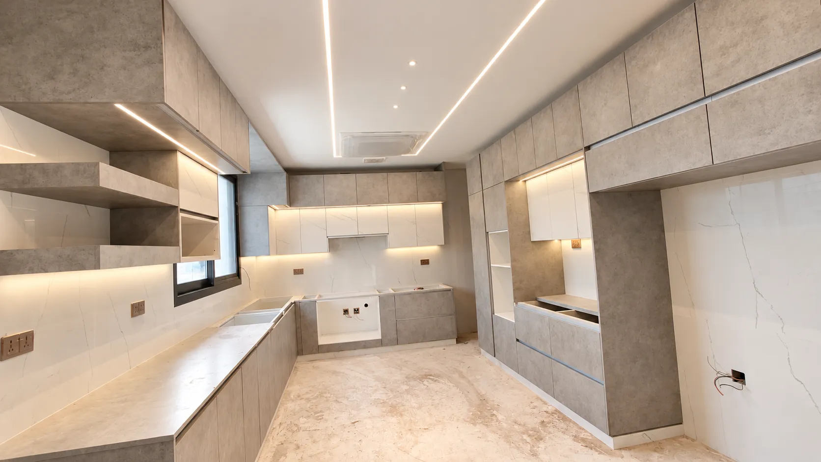 Concrete-grey kitchen cabinetry with integrated LED lighting