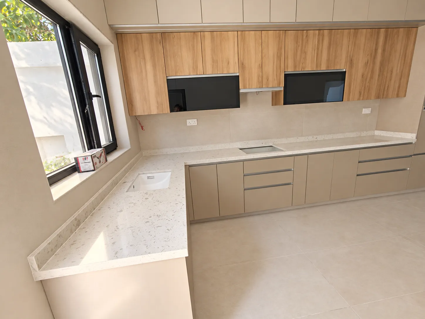 Oak and beige kitchen viewed across the worktop